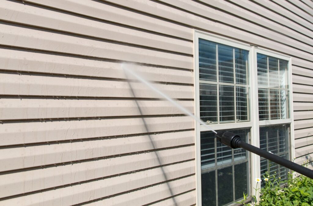 Upstate Softwash professionals performing pressure washing on a commercial storefront in Saratoga County, pressure washing near me.