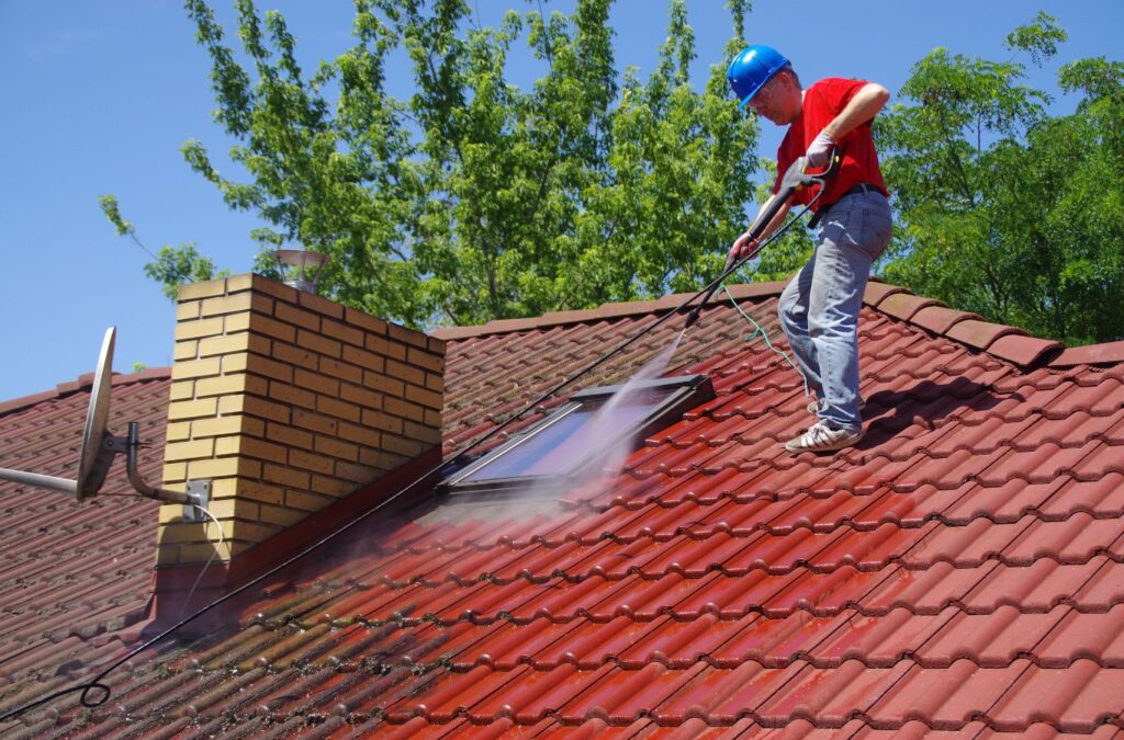 Upstate Softwash team demonstrating the benefits of roof washing in Clifton Park, NY, including extended roof lifespan and improved appearance.