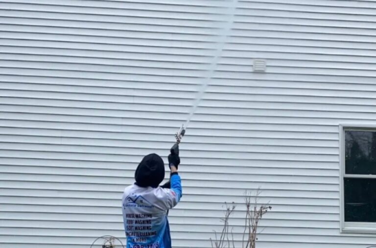 Upstate Softwash professional applying pressure washing in Latham, NY, highlighting service advantages like enhanced curb appeal and surface preservation.
