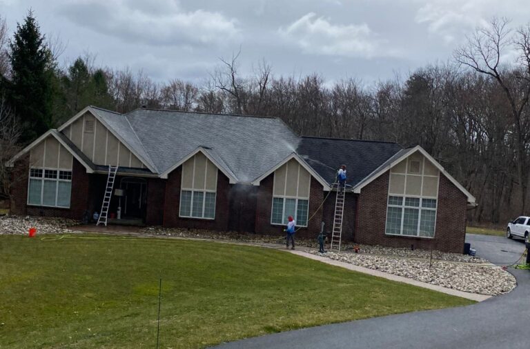 Skilled technician from Upstate Softwash expertly pressure washing in Latham, NY, showcasing why locals trust us for their cleaning needs. Pressure Washing near me.