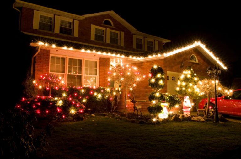 Upstate Softwash expert setting up outdoor Christmas lights in Saratoga County, NY with precision and professional tools. Christmas Lighting Installation near me.